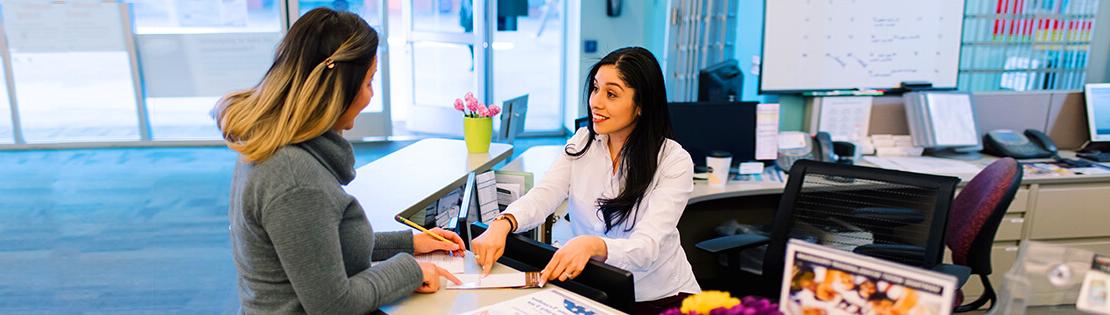 Student services employee assists a student